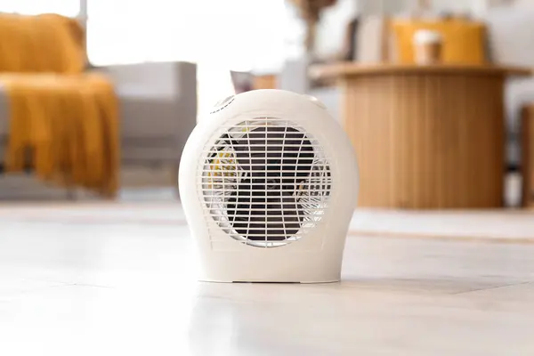 Electric fan heater on floor in living room