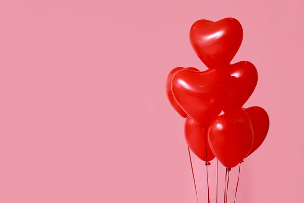 Heart-shaped balloons for Valentine\'s Day celebration on pink background