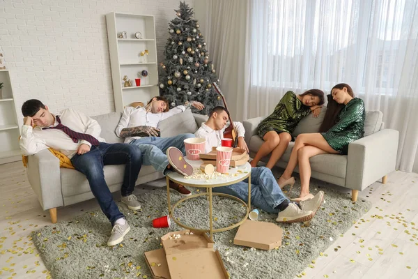 Group of drunk young people sleeping after New Year party at home