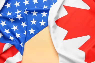 Sarı arka planda ABD ve Kanada bayrakları