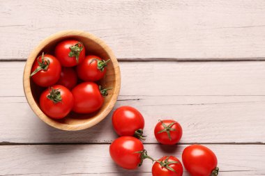 Beyaz ahşap arka planda taze kiraz domatesli kase