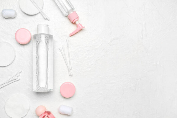 Micellar water with cotton buds and pads on white background