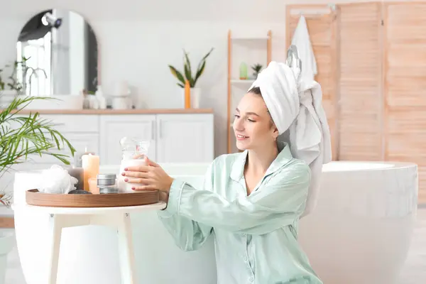 stock image Beautiful woman after shower with jug of milk in bathroom