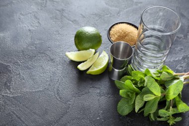 Koyu arkaplanda mojito hazırlamak için cam, ölçü ve malzeme.