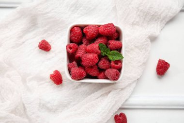 Taze ahududu ve nane arkaplanlı kase, yakın plan.