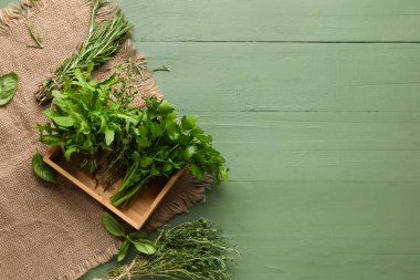 Renkli ahşap arka planda taze aromatik otlarla kompozisyon