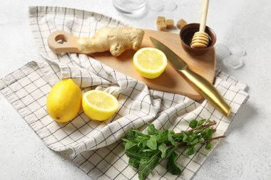 Beyaz arka planda limonata hazırlamak için malzemeler içeren ahşap tahta tahta.