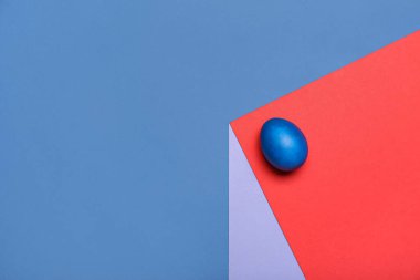 Painted Easter egg on colorful background