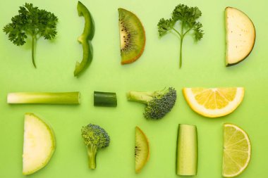 Yeşil arka planda farklı taze meyve ve sebze kompozisyonu