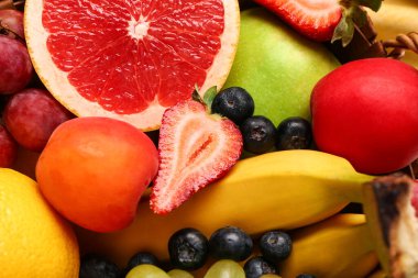 Arka plan olarak farklı taze meyveler, yakın plan