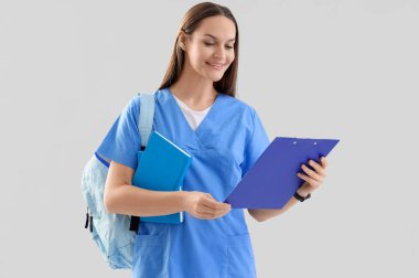 Işık arka planında panosu olan bir kadın stajyer.