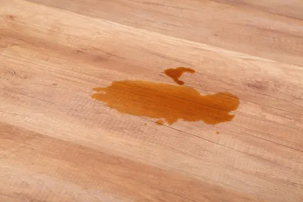 Wooden laminate floor with spilled tea