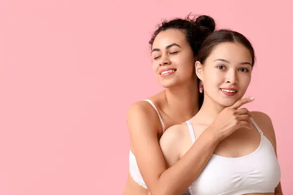 Pretty young women on pink background