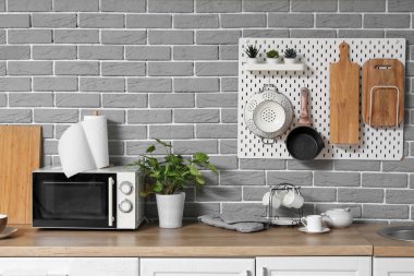 Mandallı modern mutfak, mikrodalga fırın ve çatal bıçak.