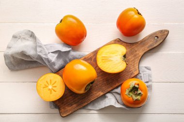 Beyaz ahşap arka planda tatlı olgun hurma ağaçları olan tahta.