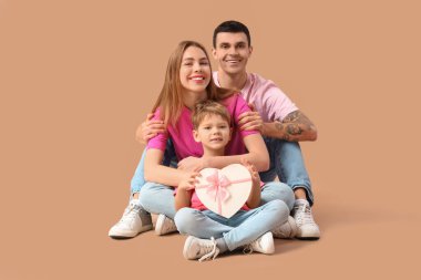 Yetenekli küçük bir çocuk ve ailesi bej arka planda oturuyor. Sevgililer Günü kutlaması