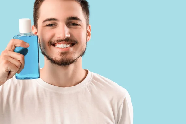 Handsome Young Man Bottle Mouthwash Blue Background Dental Care Concept — Stock Photo, Image