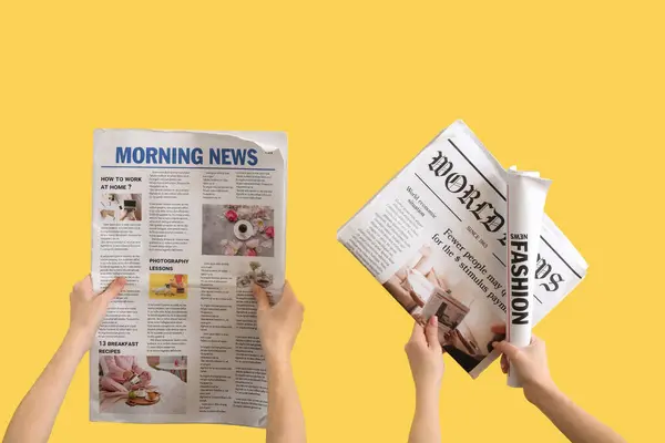 stock image Women with newspapers on yellow background