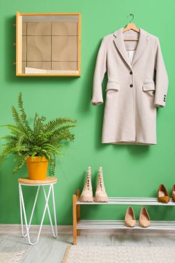 Ayna, ayakkabı standı ve ceketli modern koridorun içi.