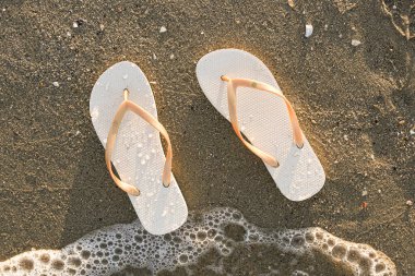 Şık kadın deniz kıyısında parmak arası terlikler