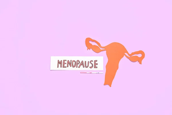 stock image Word MENOPAUSE with paper uterus and pregnancy test on pink background