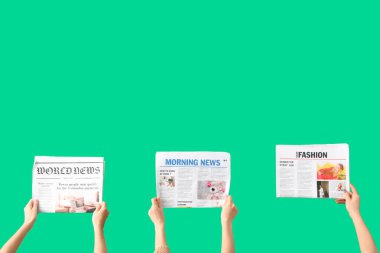 Yeşil arka planda gazeteleri olan kadınlar