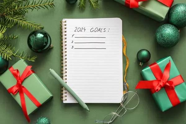 Notebook with empty to do list and Christmas decor on green background