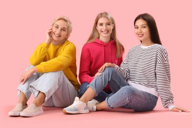 Portrait of beautiful women on pink background clipart