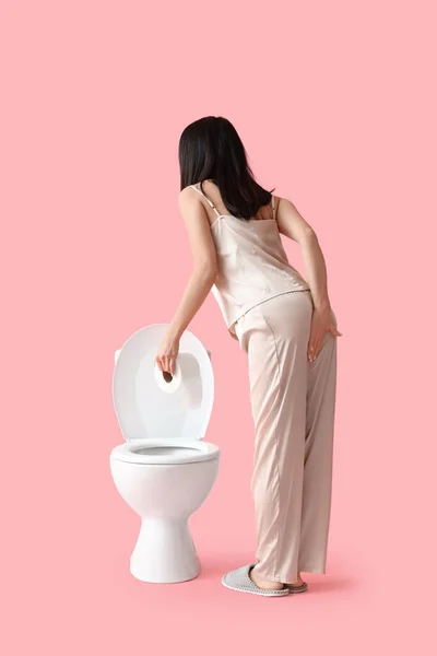 Young Woman Pajamas Hemorrhoids Toilet Bowl Pink Background Back View — Zdjęcie stockowe