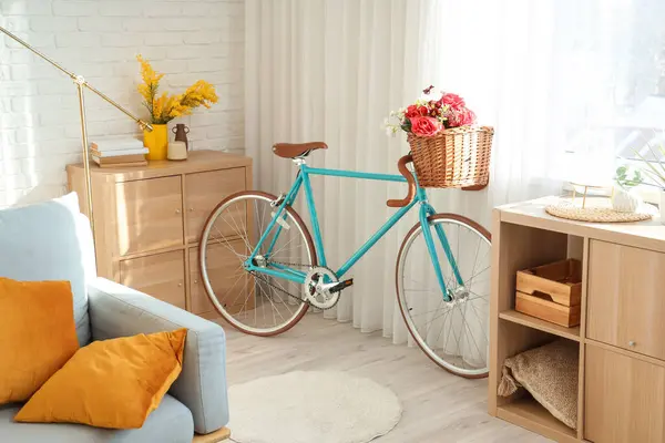Bicycle with flowers in interior of living room