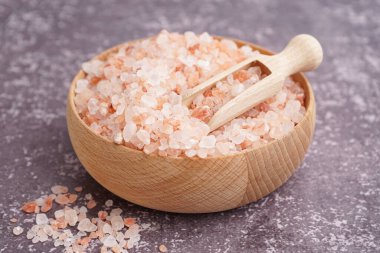 Tahta kase ve kepçe ile Himalaya pembe tuzu karanlık masa üzerinde