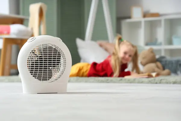 Electric fan heater in children\'s bedroom, closeup