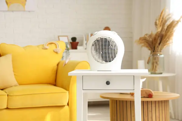 Electric fan heater on table in children's room