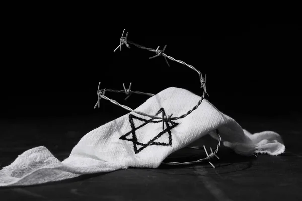 Jewish armband with barbed wire on black background. International Holocaust Remembrance Day