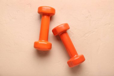 Bej arkaplanda turuncu halterler