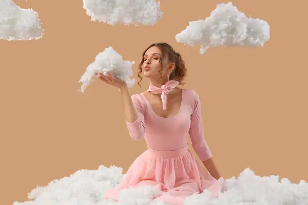 stock image Beautiful young woman with white clouds blowing on beige background