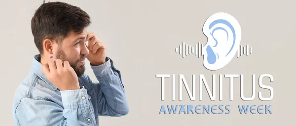 Stock image Banner for Tinnitus Awareness Week with young man having hearing disorder