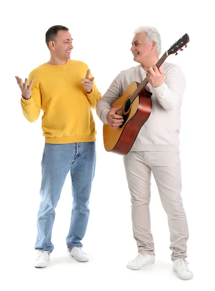 stock image Mature brothers with guitar on white background