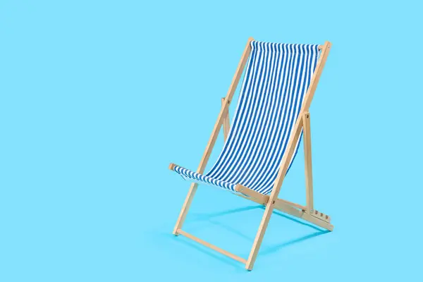Striped deck chair on blue background
