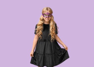 Leylak arka planında karnaval maskesi takan komik küçük kız.