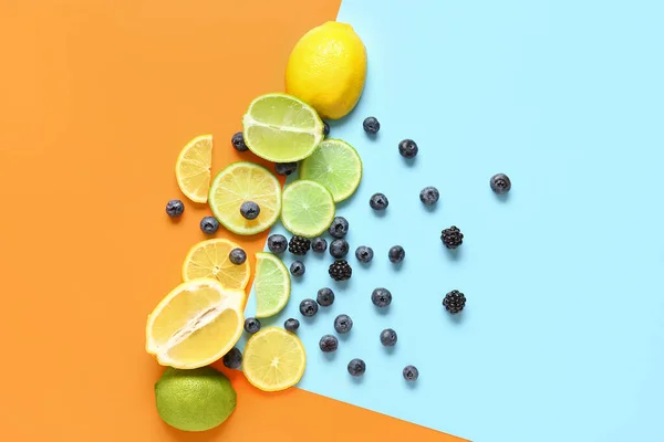 Composition with fresh citrus fruits and berries on color background