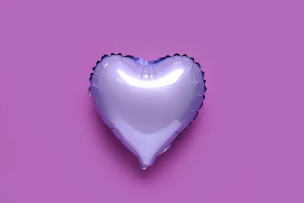 Heart shaped air balloon on purple background. Valentine\'s Day celebration