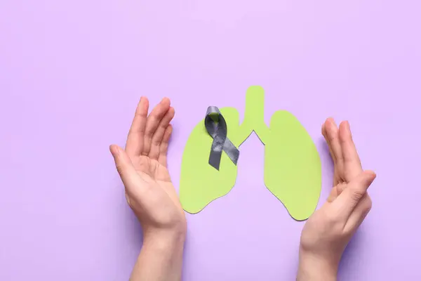 Руки Женщины Серой Лентой Бумажными Легкими Фиолетовом Фоне — стоковое фото