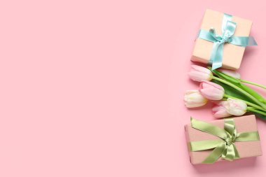 Pembe arka planda güzel laleler ve hediye kutuları. Uluslararası Kadınlar Günü