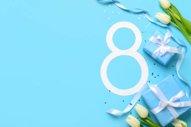 Hediye kutuları ve mavi arka planda güzel laleleri olan 8 numara. Uluslararası Kadınlar Günü