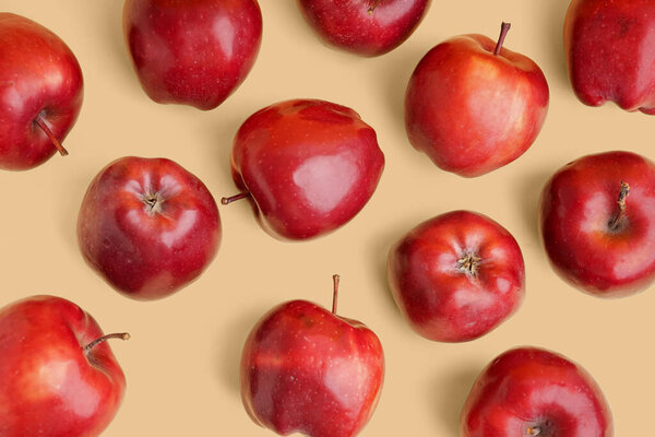 Fresh red apples on yellow background
