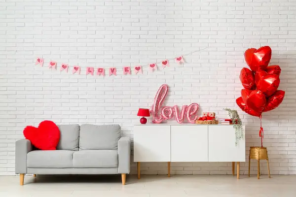 Interior of festive living room with heart-shaped balloons and decorations for Valentine\'s Day celebration