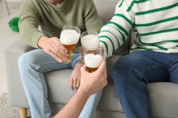 Men with glasses of beer at home. St. Patrick\'s Day celebration