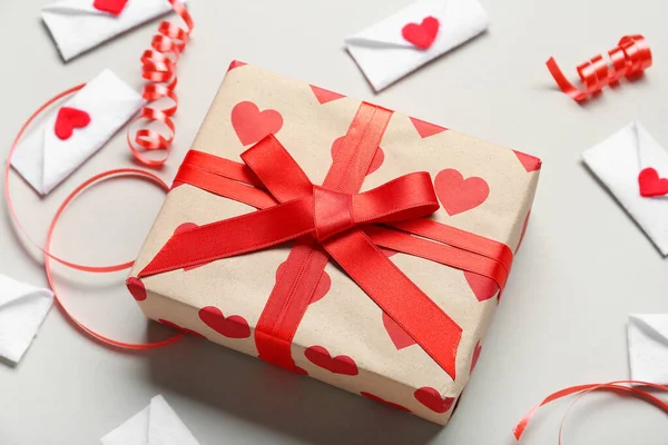 Gift box and envelopes on grey background. Valentine\'s Day celebration