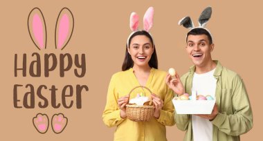 Tavşan kulaklı mutlu genç çift ve bej arka planda Paskalya sepetleri. Paskalya bayrağı